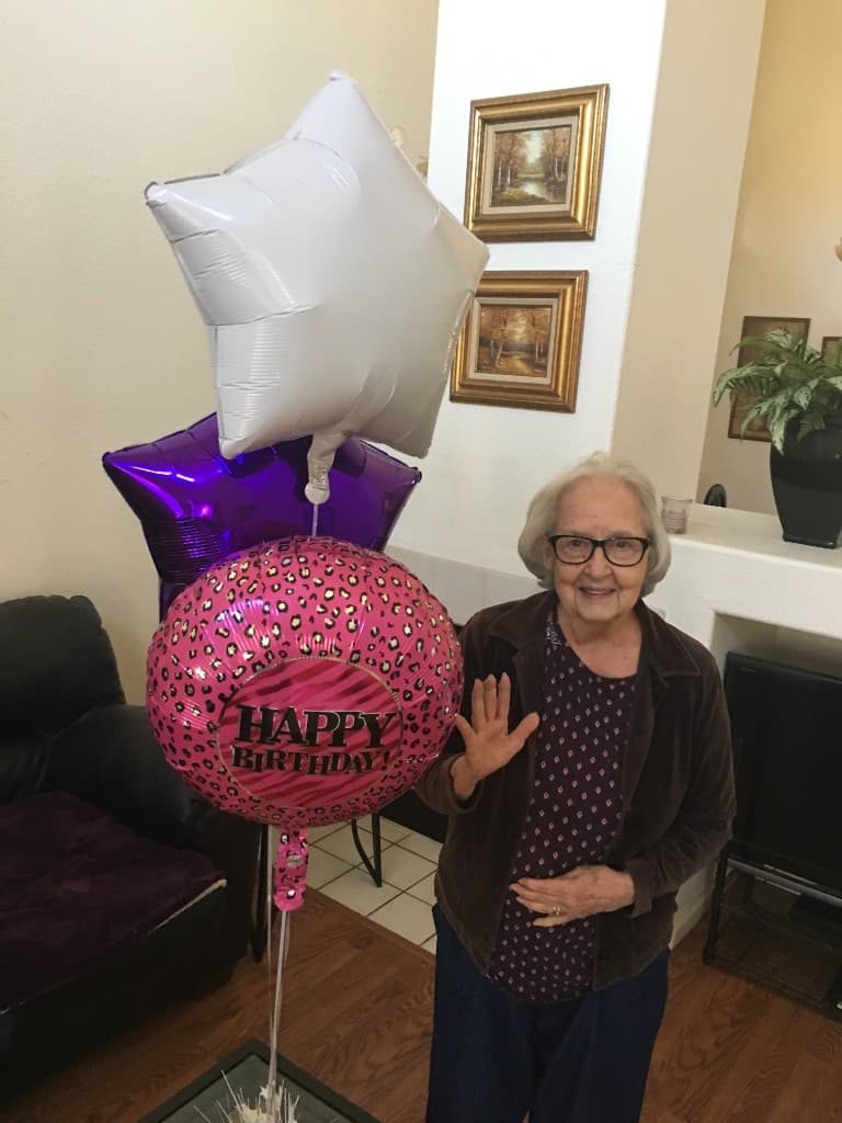 Birthday celebration with balloons and a warm smile