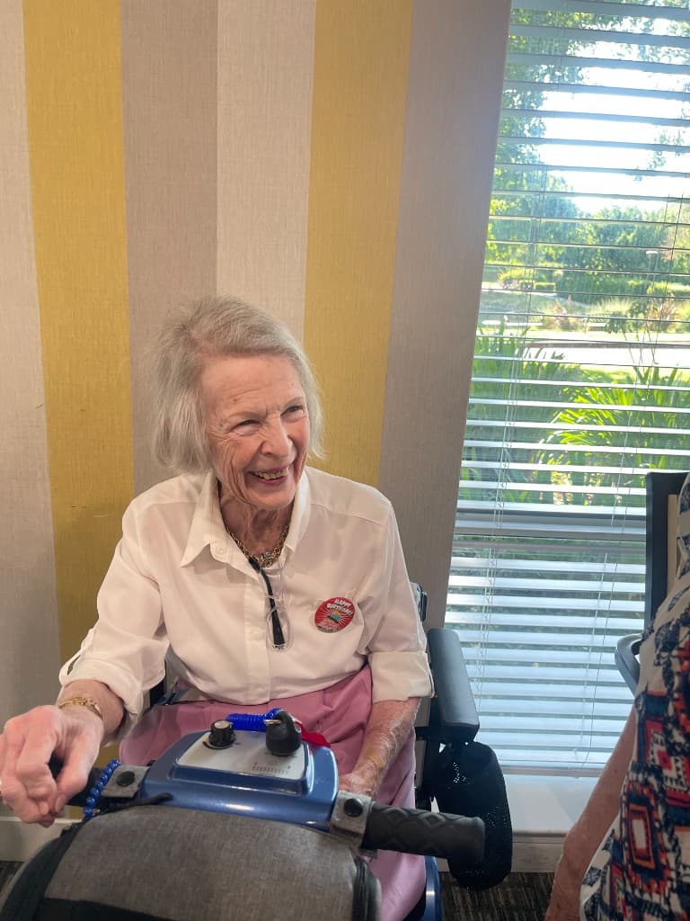 Client smiling during a community birthday celebration