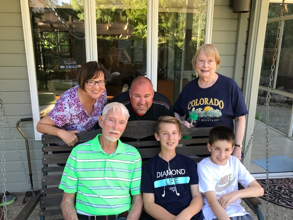 Multi-generational family gathered on a porch
